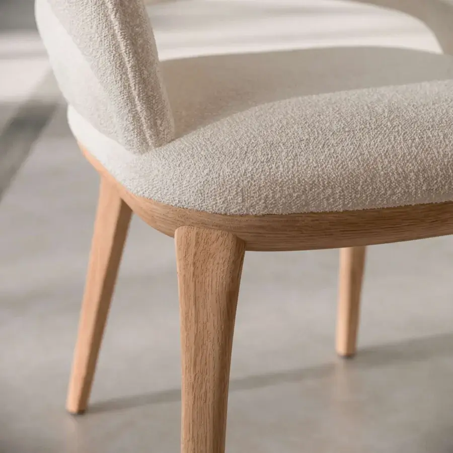 Superior Ozzio Italia Baia chair with sinuous curves upholstered in textured light beige textile and a light natural solid ash structure