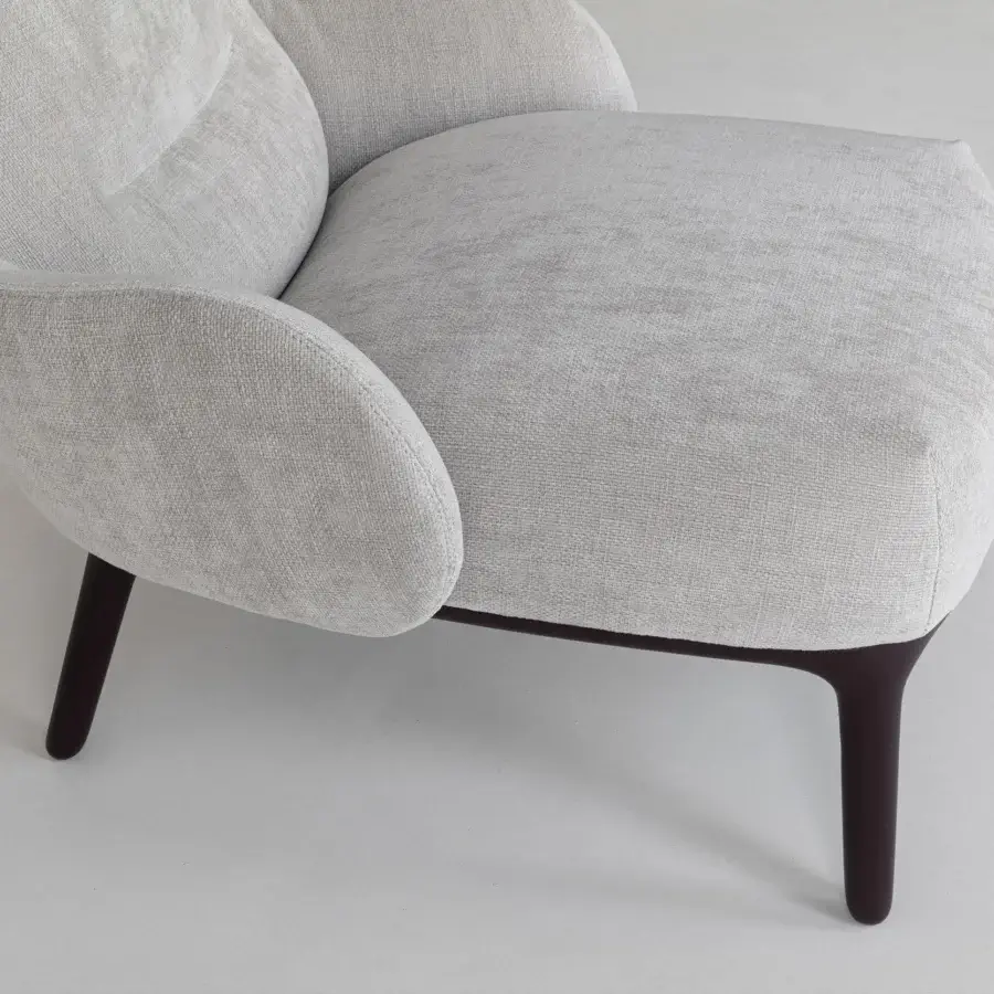 Elegant Cierre1972 Woody lounge chair with light gray matte textile and tapered dark-toned wood legs
