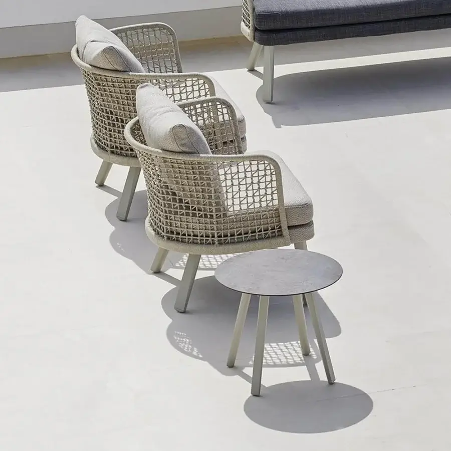 Sophisticated Varaschin Emma side table with circular bush-hammered ceramic top and light gray aluminum legs
