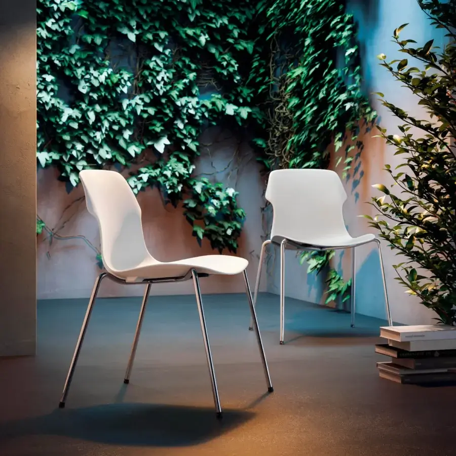 Exceptional Casamania Stereo chair showcasing modern curved lines with smooth white finish and slender metal legs