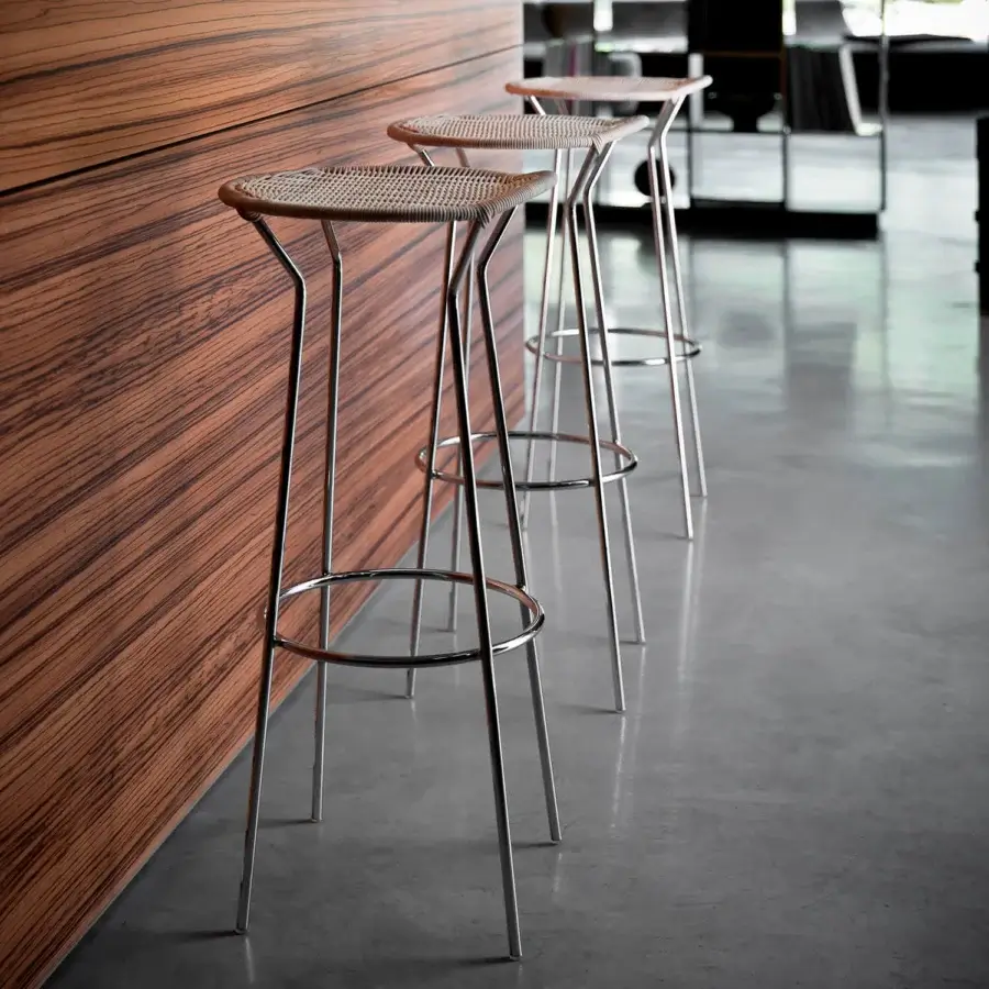 Distinguished Casamania bar stool with natural woven wicker structure and sleek silver chromed metal frame