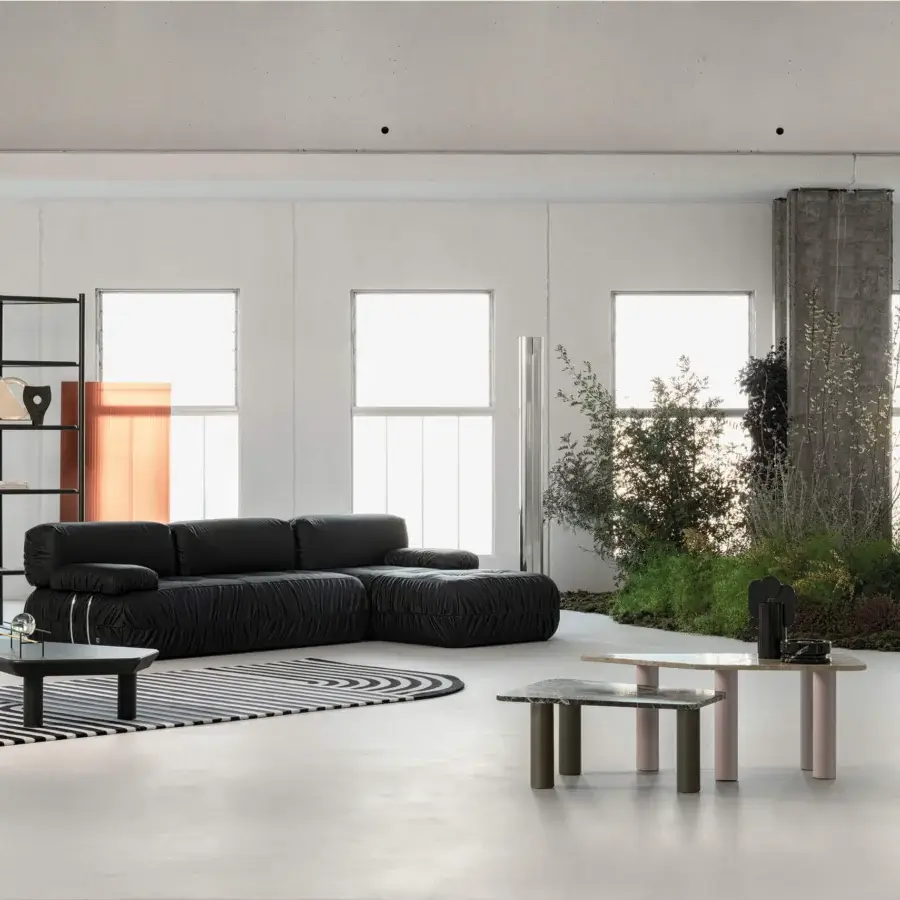 Distinguished Cierre1972 Option sectional with matte black textile and quilted horizontal indentations creating a contemporary silhouette
