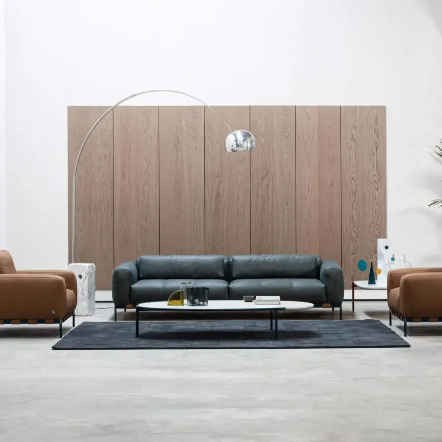 Exclusive Cierre1972 Oscar sofa with matte gray textile upholstery and a sleek metal base built with chromed details