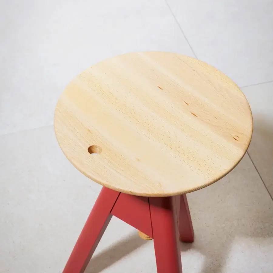 Distinctive Miniforms Vitos stool with vibrant red legs and light natural wood seat exhibiting a modern aesthetic