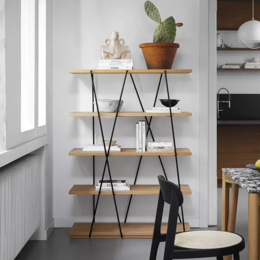 Elegant Miniforms Matassa bookcase with black metal lines wrapping smooth, matte, light-toned wooden shelves