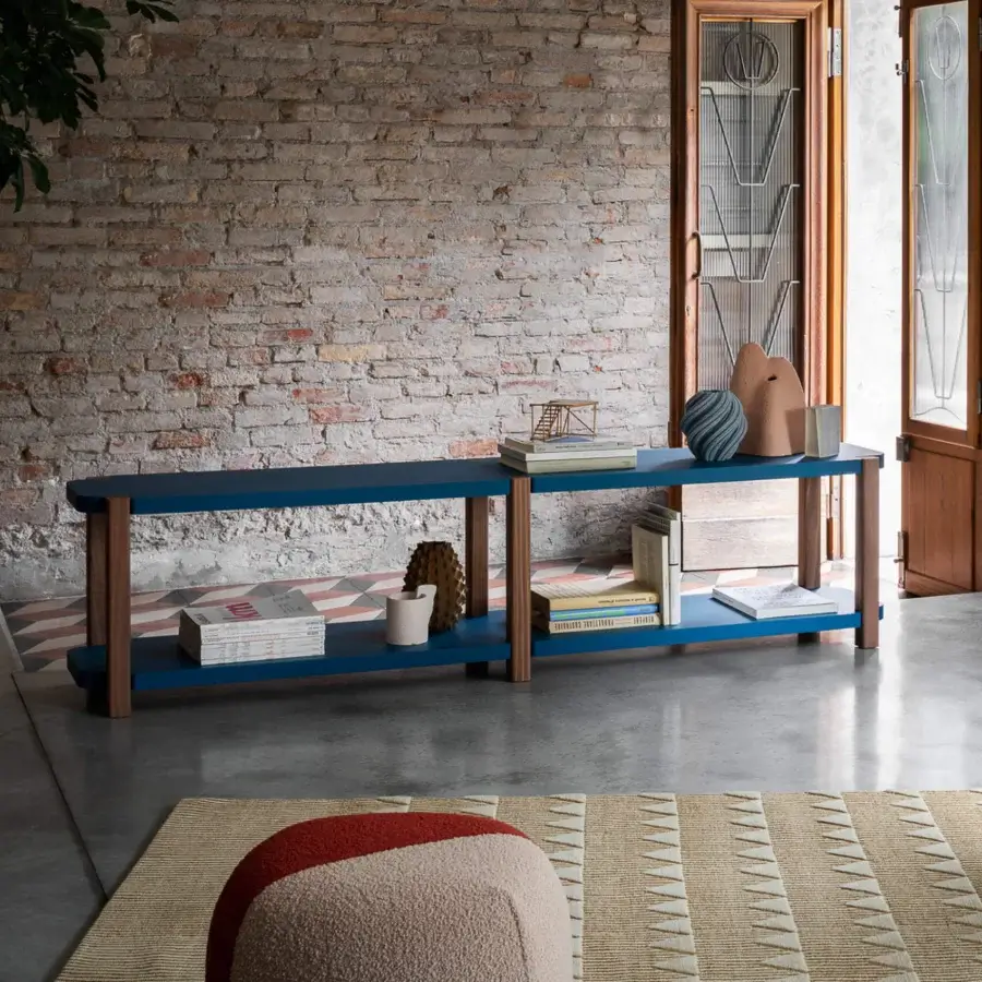 Distinguished Miniforms Palinfrasca bookcase with deep blue shelves and natural wood tone legs exhibiting curved details