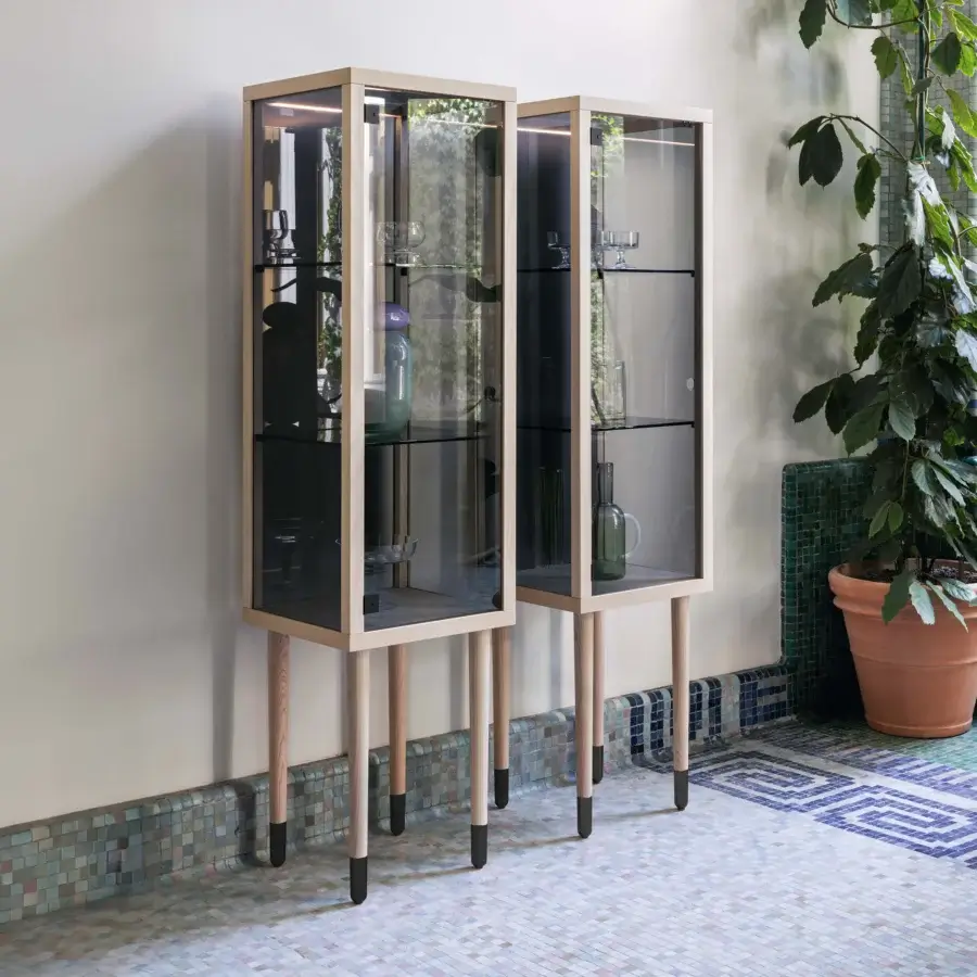 Exceptional Miniforms Juno bar cabinet with neutral light-toned matte wood and glass panels supported by cylindrical wooden legs