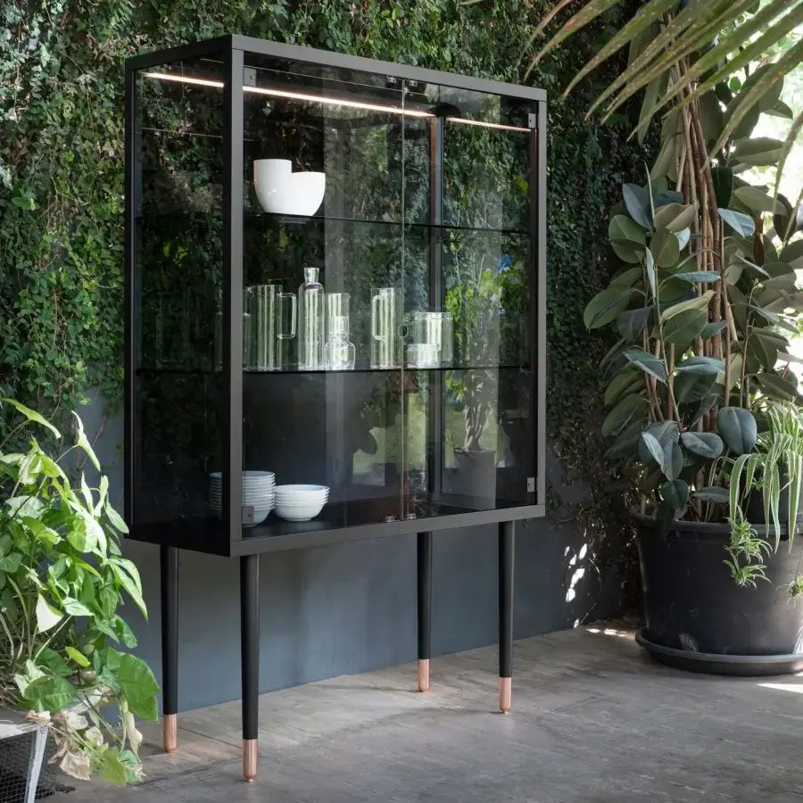Superior Miniforms Juno bar cabinet with matte black metal frame, glass panels and neutral-toned illuminated interior