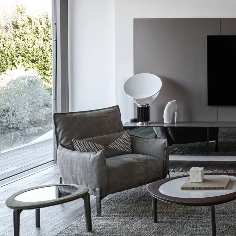 Superior Cierre1972 Tulip lounge chair with solid gray textile upholstery and reflective metal legs crafted with raw-cut seams