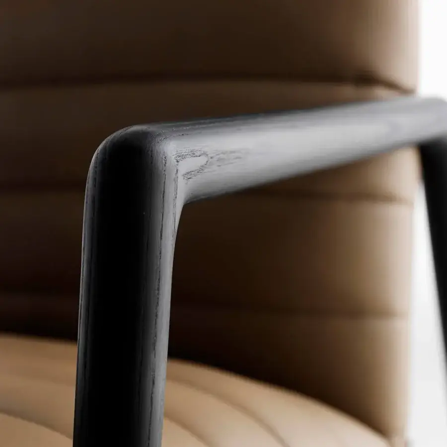 Exceptional Horm Carnaby lounge chair with tan upholstery and black wood armrests exhibiting horizontal stitched channels with a matte finish