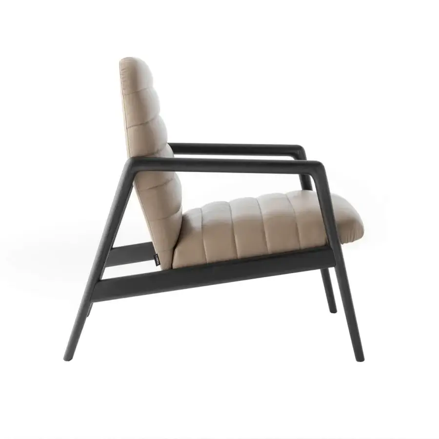 Distinguished Horm Carnaby lounge chair with light tan upholstery and a matte finished wooden base exhibiting ergonomic design