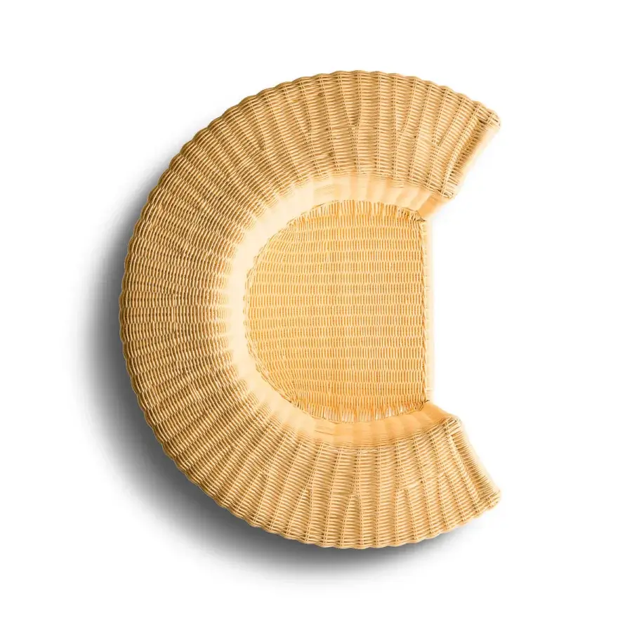 Architectural Horm Charlotte lounge chair with light tan handwoven natural wicker creating a continuous, monolithic form