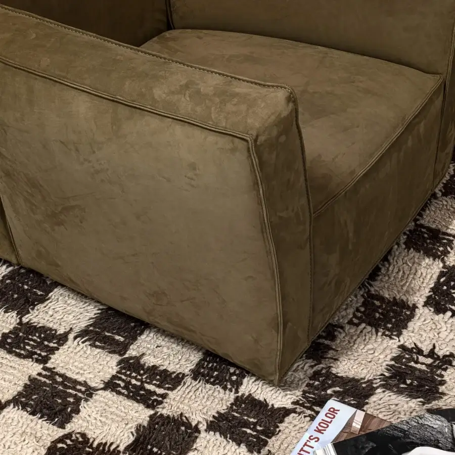 Harmonious Cierre1972 Season lounge chair with matte olive green textile upholstery and flat-fell pinched seam detailing