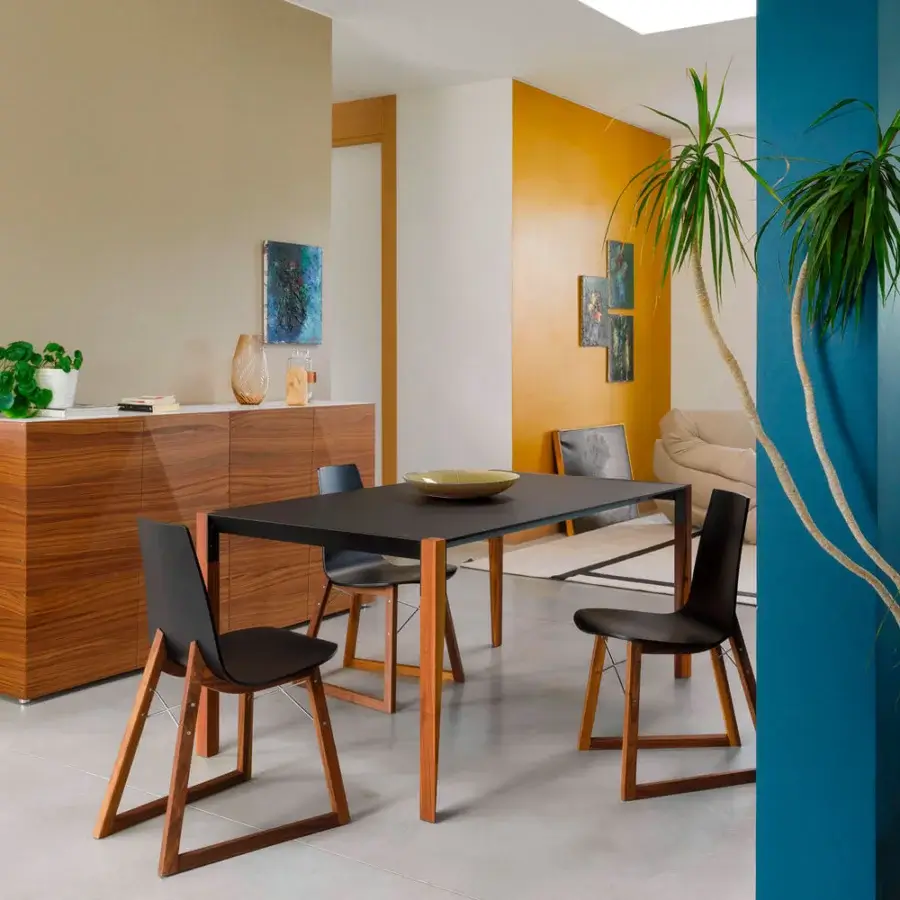 Sophisticated Horm Ray chair with curved dark lacquered plywood and a solid premium wood base built with chrome-plated steel cross-bars