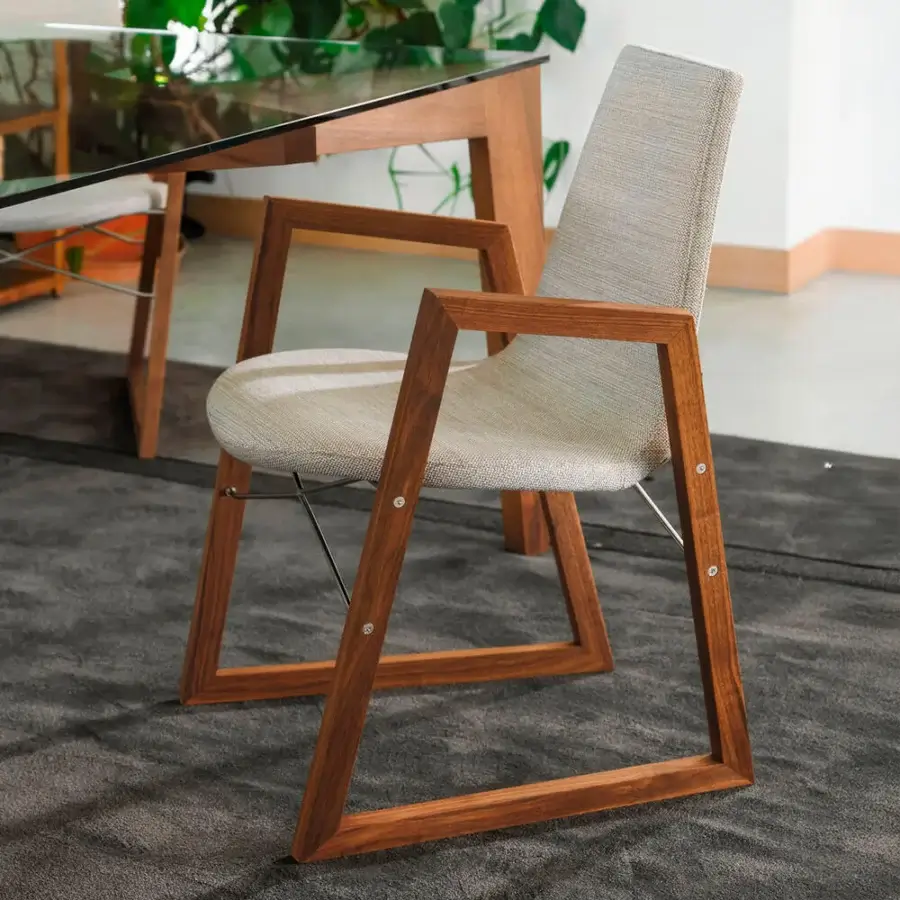 Captivating Horm Ray armchair with light gray textile upholstery and a warm brown solid wood structure with chrome-plated steel cross-bars