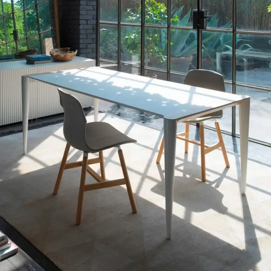 Innovative Horm Bolero table with white Fenix tabletop and sleek legs crafted in Italy for lightness