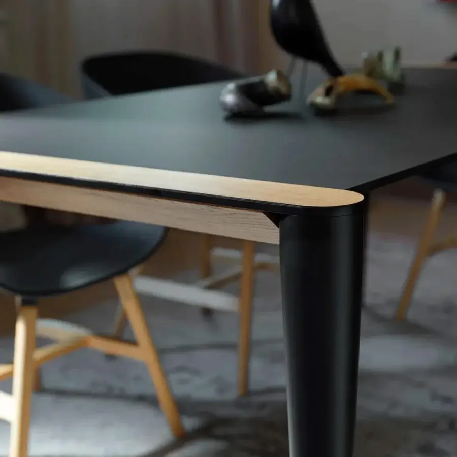 Superior Horm Bolero table with matte black Fenix top and light-toned wooden frame crafted with cylindrical black metal legs