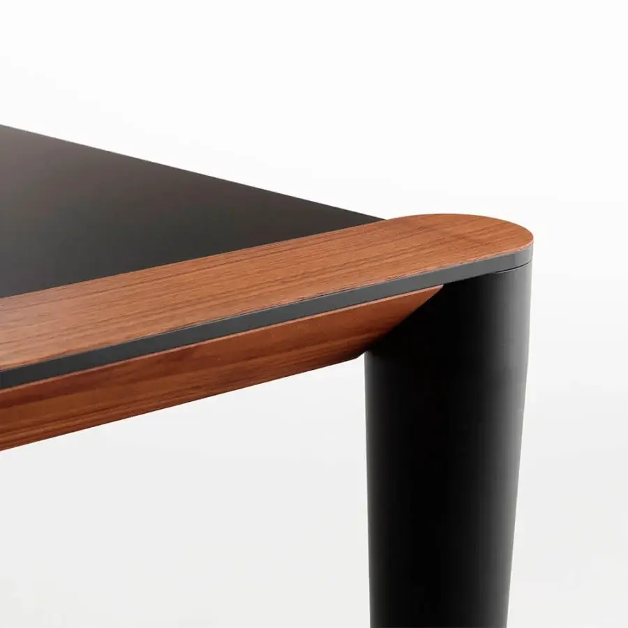 Distinguished Horm Bolero table crafted with a Fenix top and Canaletto walnut, featuring sleek black cylindrical legs
