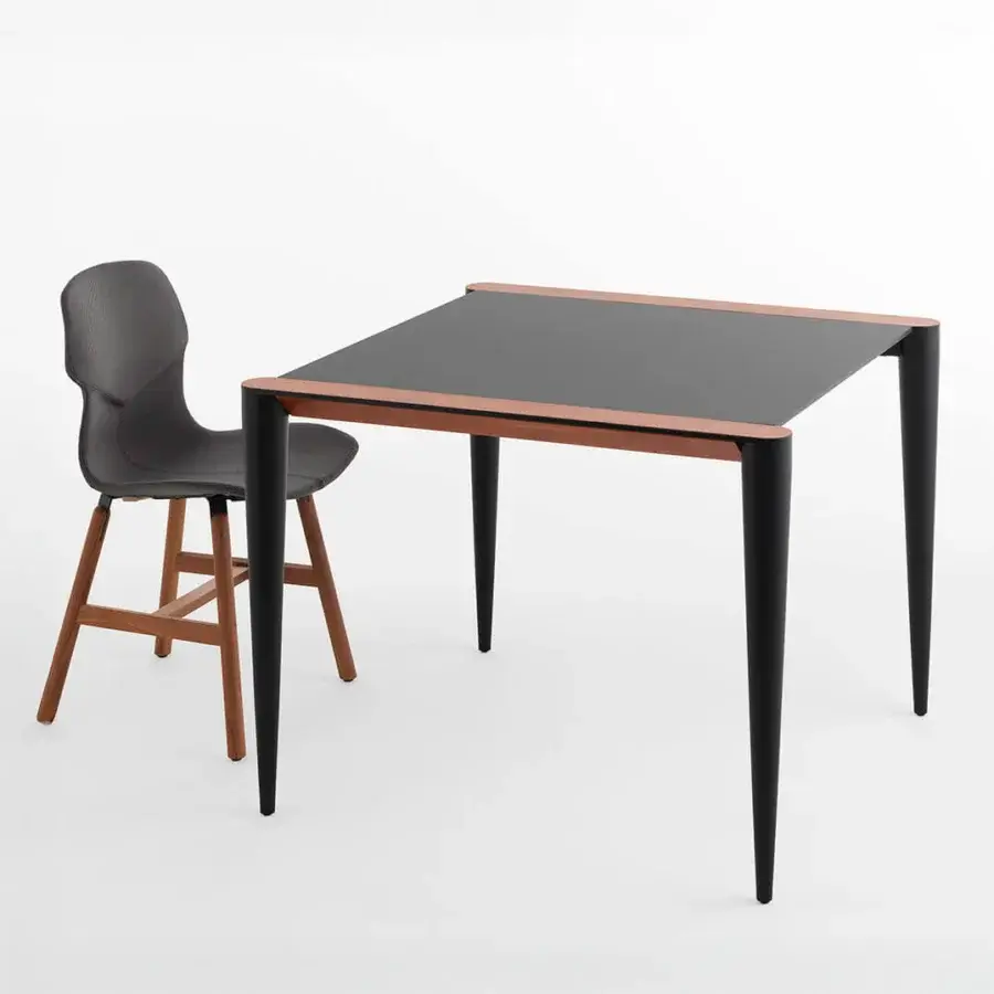 Exceptional Horm Bolero Bistrot table with square Fenix tabletop and hand-applied Canaletto walnut details, built with sleek tapered black legs