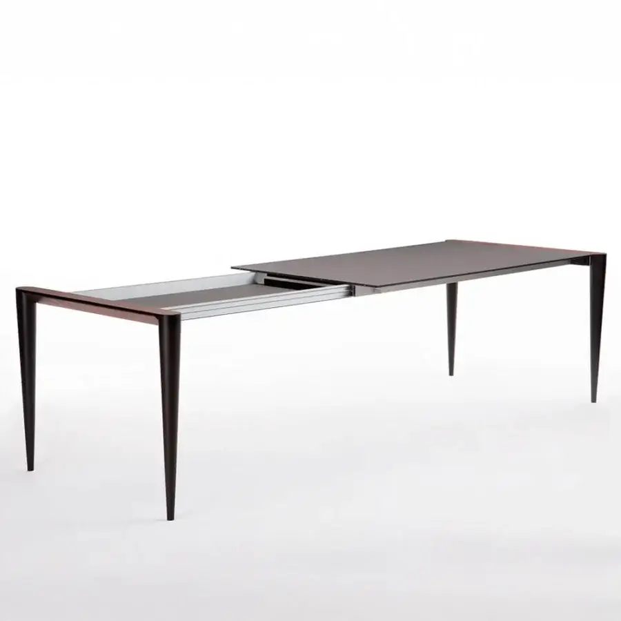 Exceptional Horm Bolero extendable table with a matte Fenix tabletop and hand-applied Canaletto walnut details in a dark finish