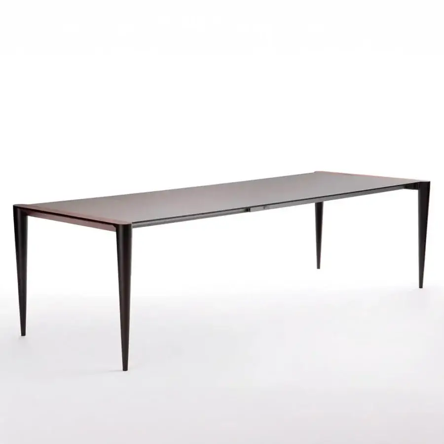 Superior Horm Bolero extendable table crafted with a Fenix tabletop and Canaletto walnut details in a dark-toned finish