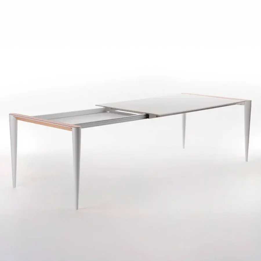 Innovative Horm Bolero extendable table with white Fenix top and hand-applied natural oak details creating a spacious design