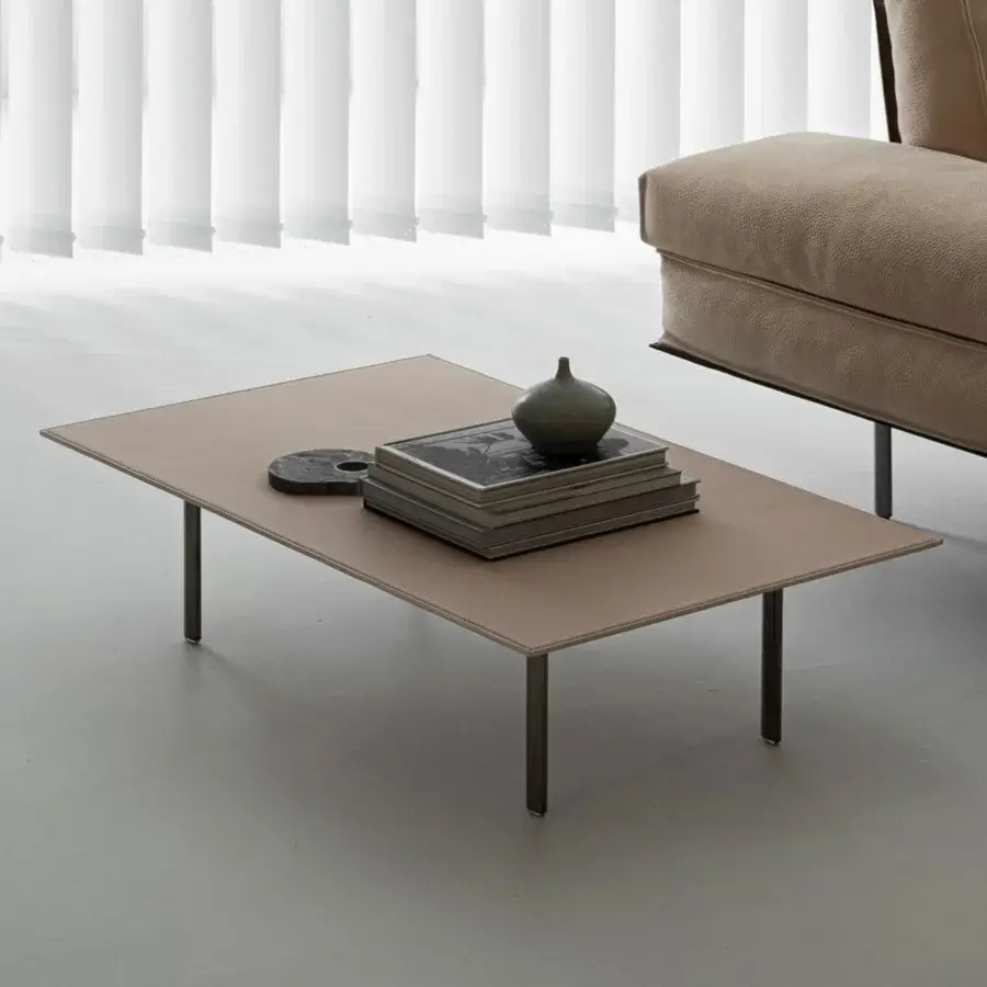 Elegant Cierre1972 Vogue Cuoio coffee table with light brown raw-cut leather and sleek dark-toned metal legs
