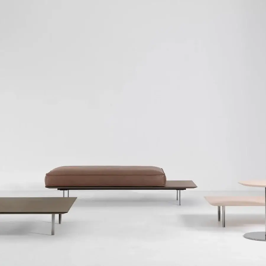 Refined Cierre1972 Vogue Cuoio coffee table with raw-cut leather surface and sleek metal legs in matte greyish-brown wood