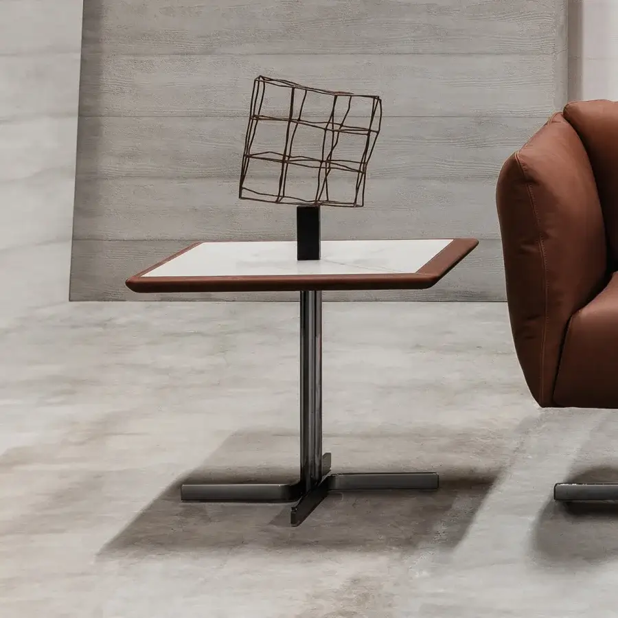 Distinguished Cierre1972 Laurel&Hardy side table with marble-effect ceramic top and rich leather edge built upon a slender metal base