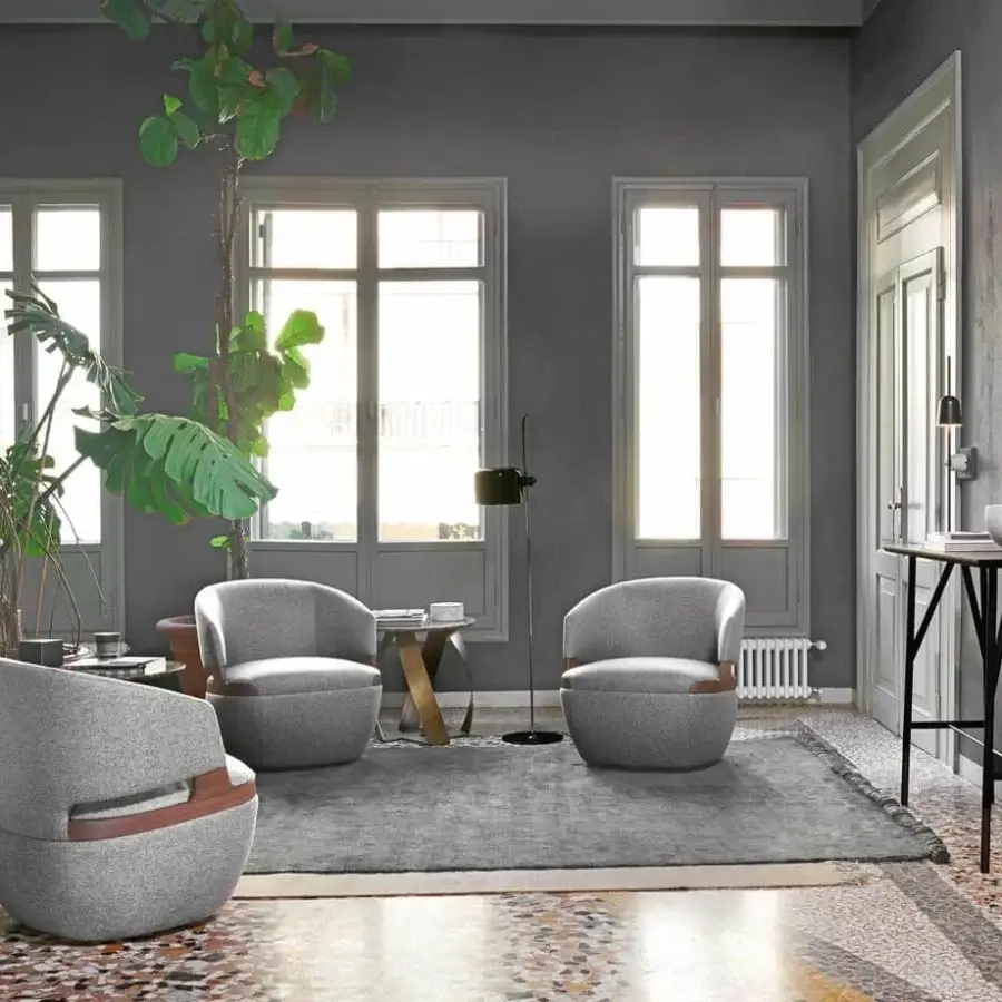 Superior Potocco Velis lounge chair with a rotating base upholstered in matte grey fabric and Canaletto walnut armrests