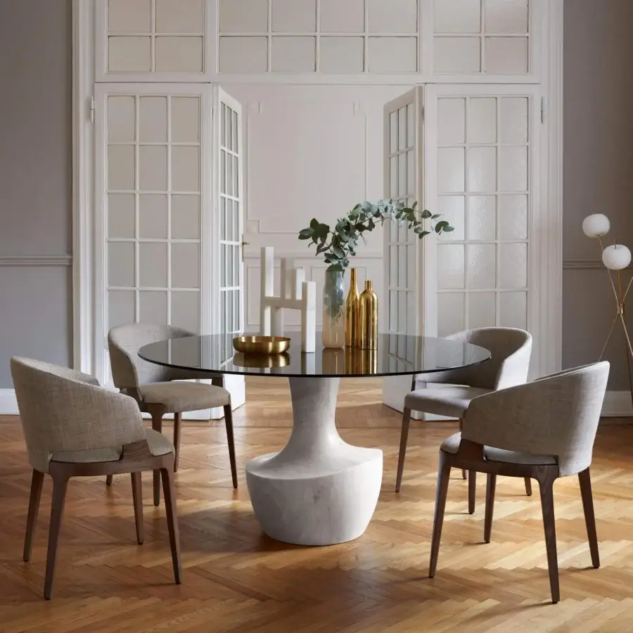 Distinguished Potocco Anfora table with sculpted marble base and sleek round glass top crafted in Italy