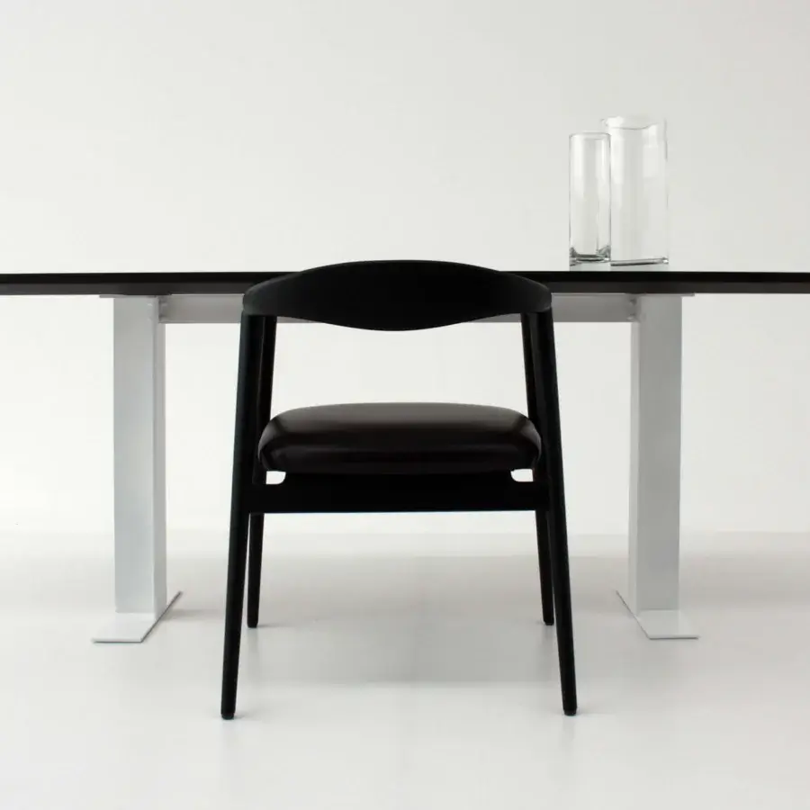 Distinguished Casa Casati Romy armchair built with dark upholstery and refined matt black finished wooden legs