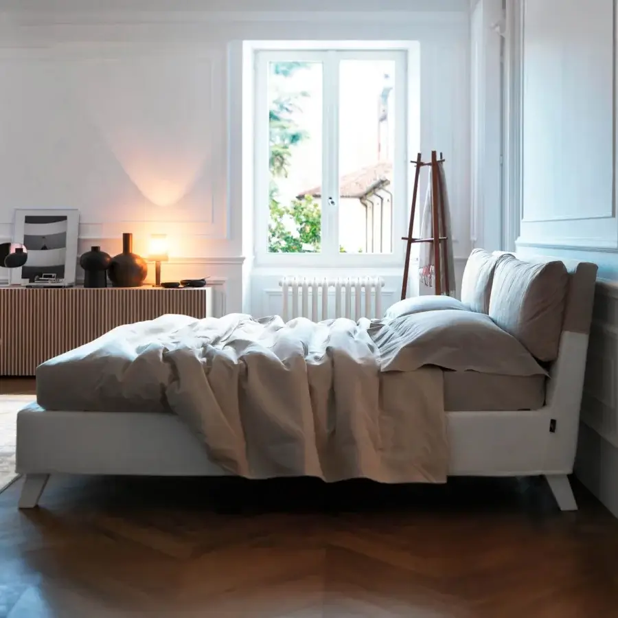 Lavish Horm Bahamas bed with light beige fabric upholstery and white lacquered solid beechwood legs