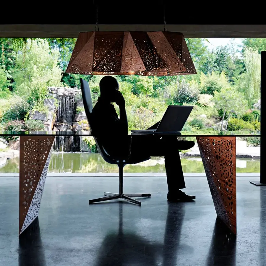 Superior Horm Plywood Suspension Lamp crafted in medium brown laser-etched plywood with geometric perforations creating shadow plays