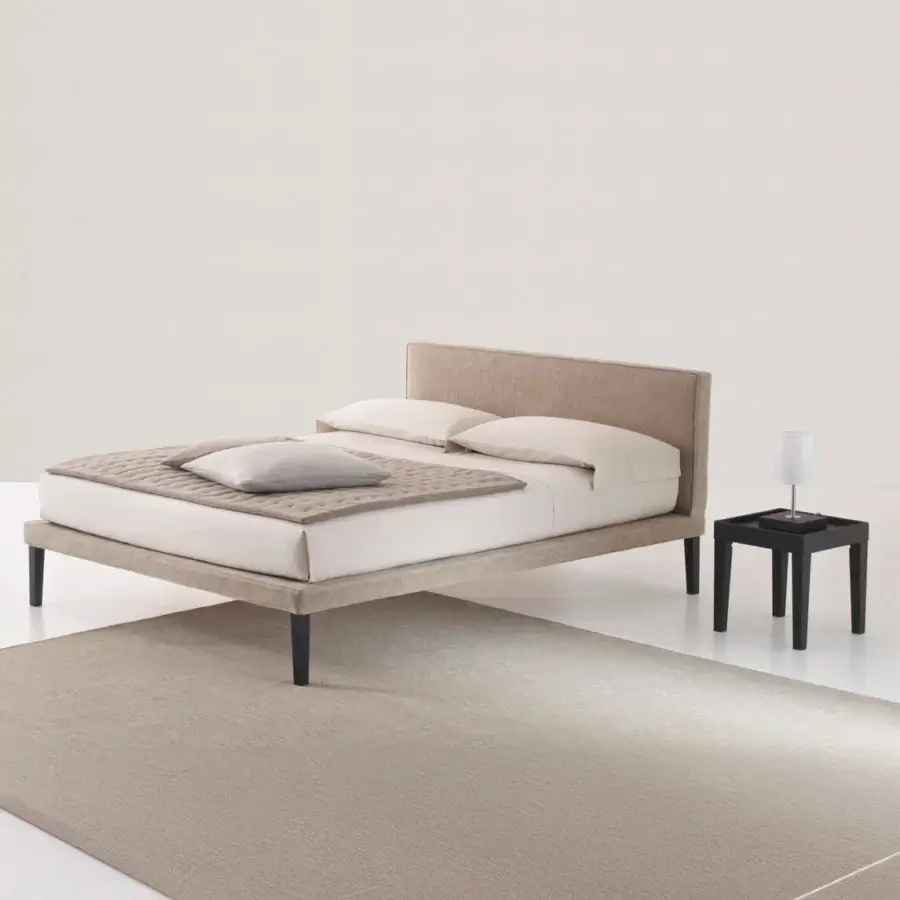 Distinguished Horm Ebridi bed crafted in Italy with light brown textile upholstery and dark beechwood legs
