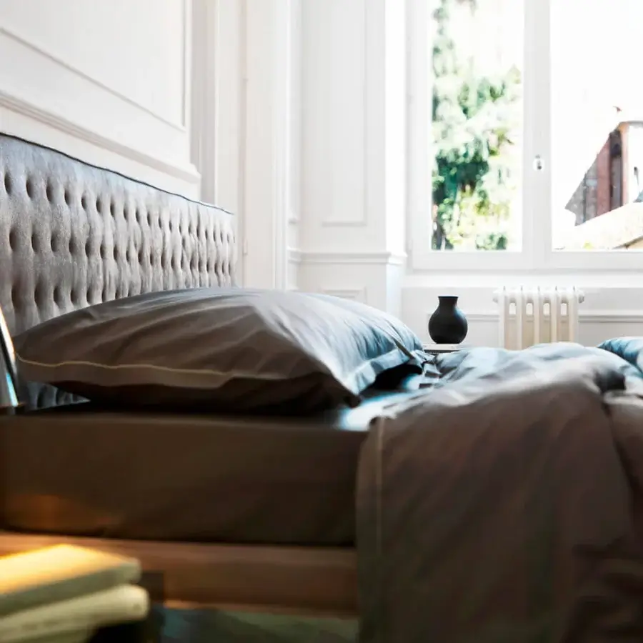 Exceptional Horm Ebridi bed with soft gray textile upholstery and solid beechwood feet finished with mocha lacquer