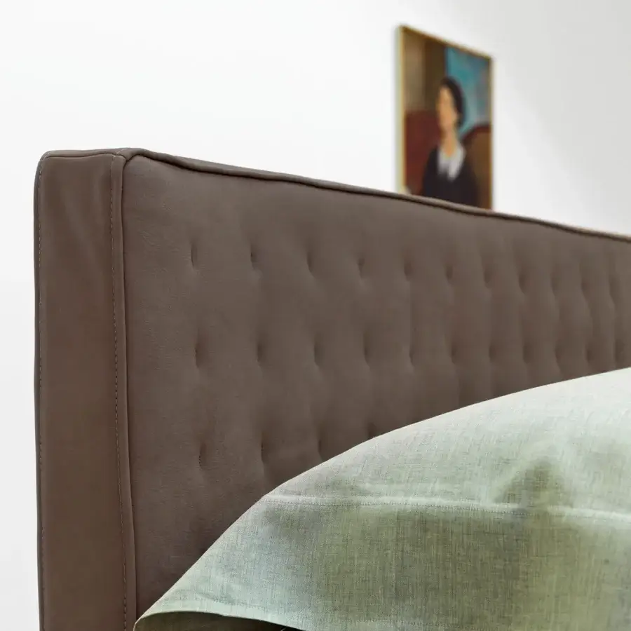 Lavish Horm Ebridi bed with button-tufted headboard upholstered in rich brown material and mocha lacquered beechwood feet