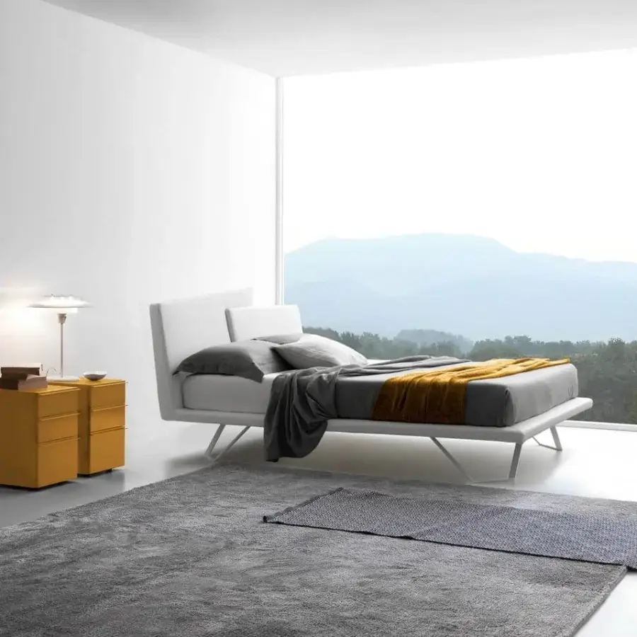 Distinguished Presotto Meeting bed with trapezoidal headboard upholstered in crisp white fabric and low-profile metal frame supporting a gray mattress