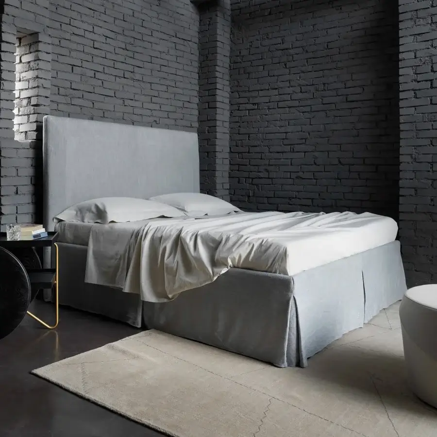 Distinguished Horm Sardegna bed with light gray textile upholstery and concealed beechwood feet offers contemporary style