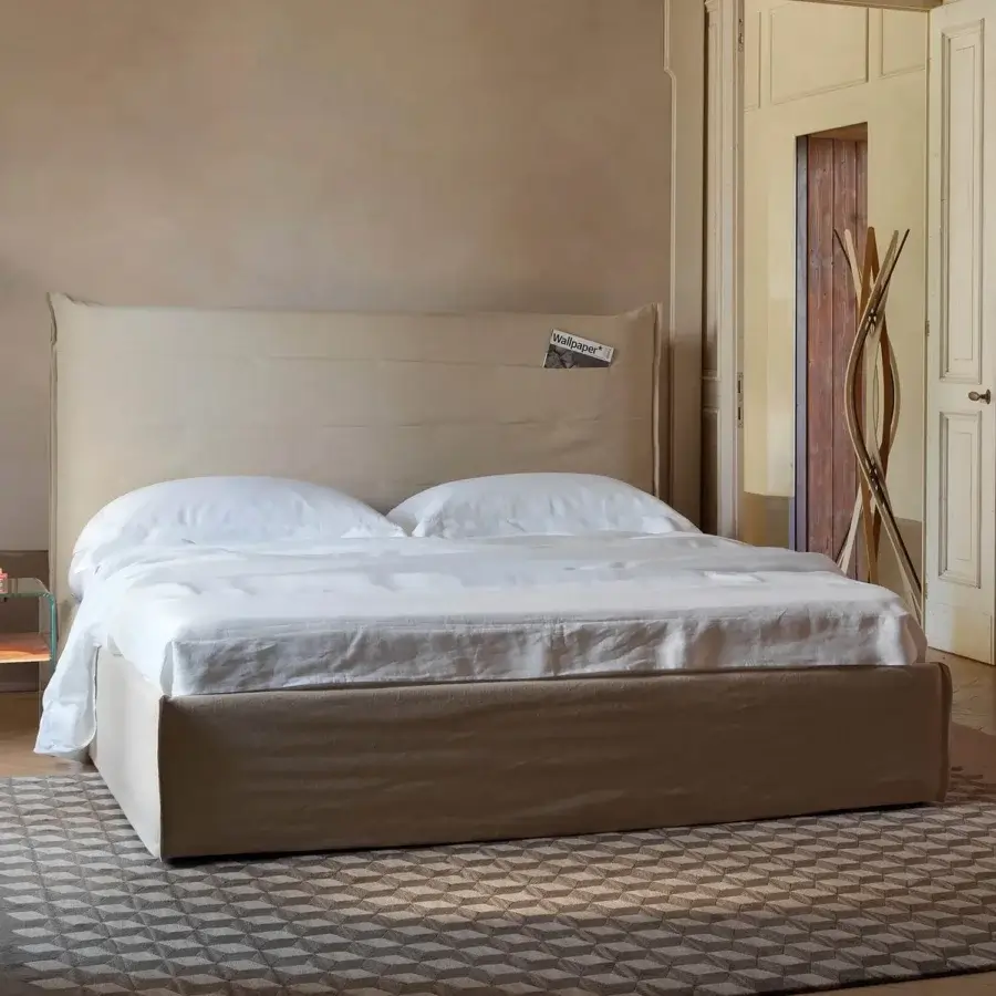 Superior Horm Tasca bed with light beige textile upholstery and white lacquered solid beechwood feet