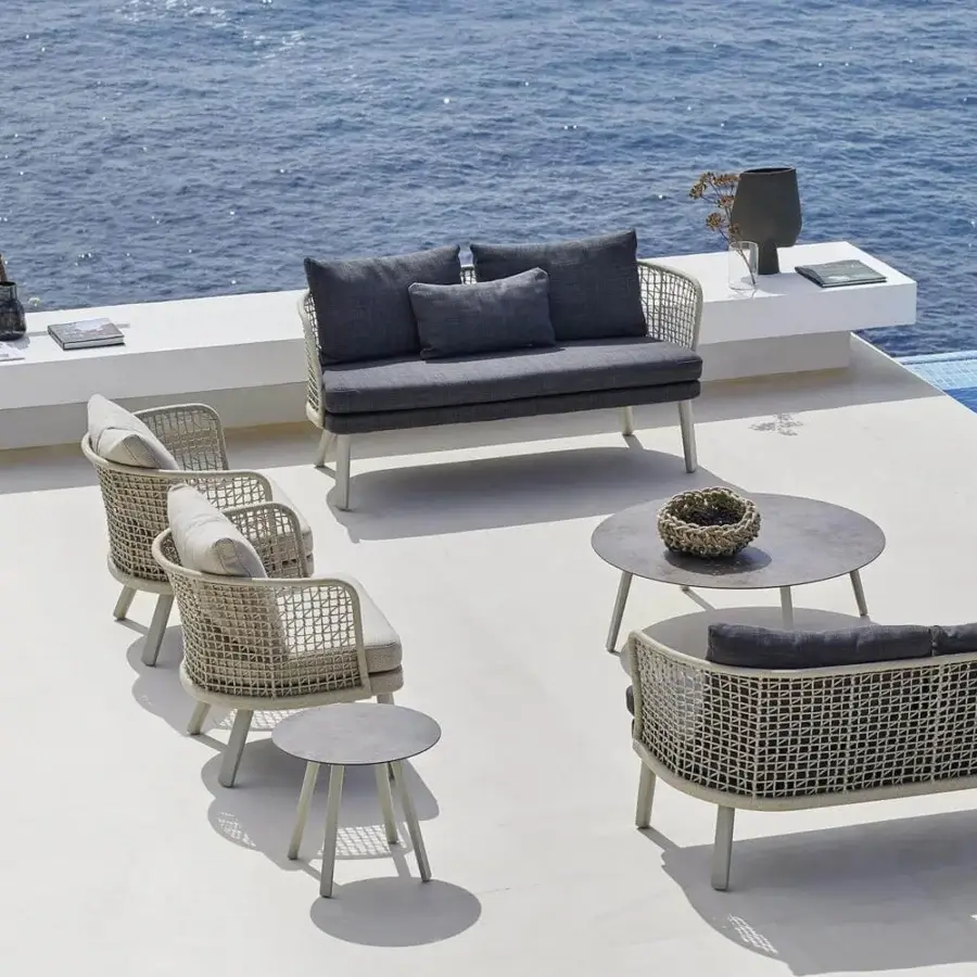 Refined Varaschin Emma sofa with light beige hand-woven aluminum frame and dark gray upholstery built with powder-coated aluminum legs