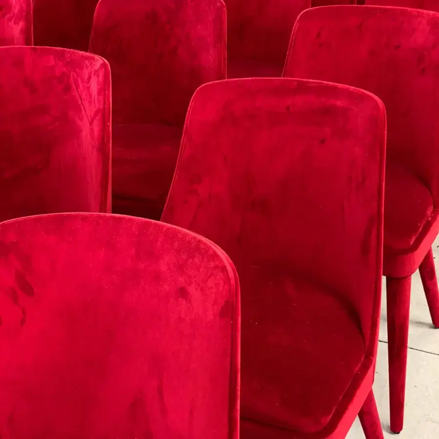 Lavish Casa Casati Lola chair upholstered entirely in vibrant red velvet with gracefully curving back and beech wood legs