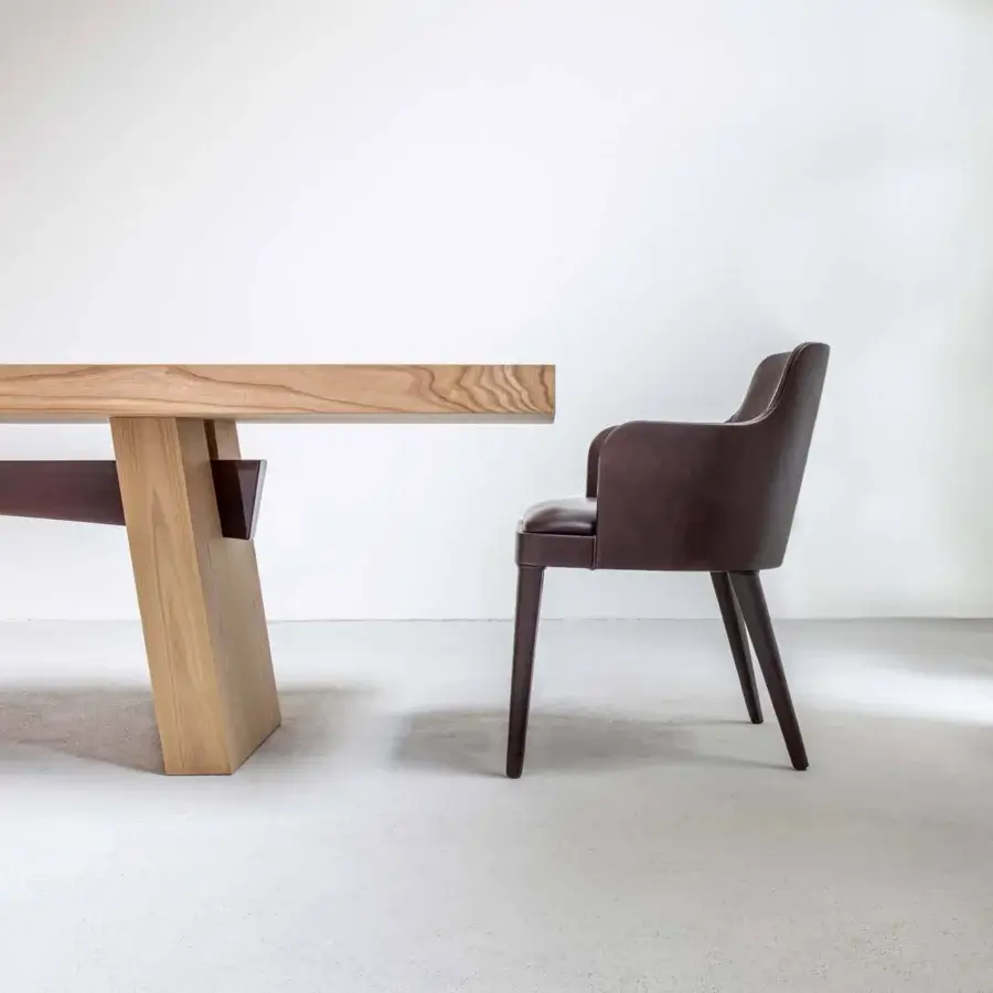 Elegant Casa Casati Lola chair with curving back and arms upholstered in dark brown leather with dark stained beech wood legs