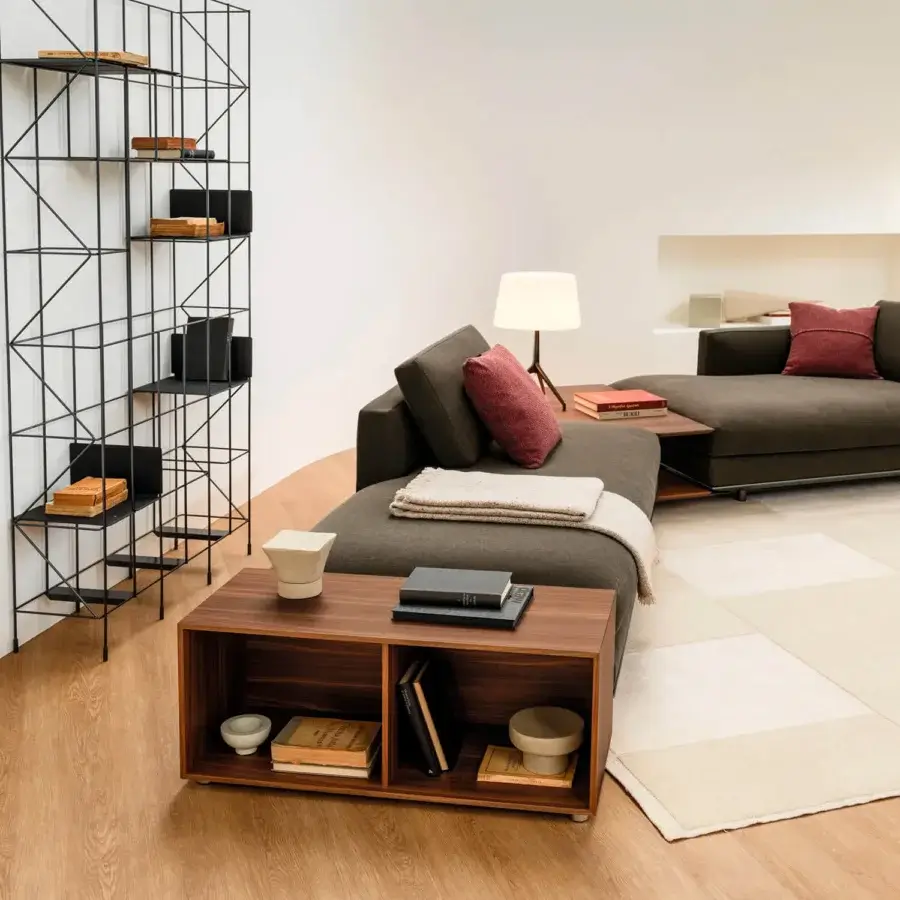 Elegant Horm Miles sectional with a light aluminum frame upholstered in dark muted brown textile exhibiting a matte finish and red accent pillows