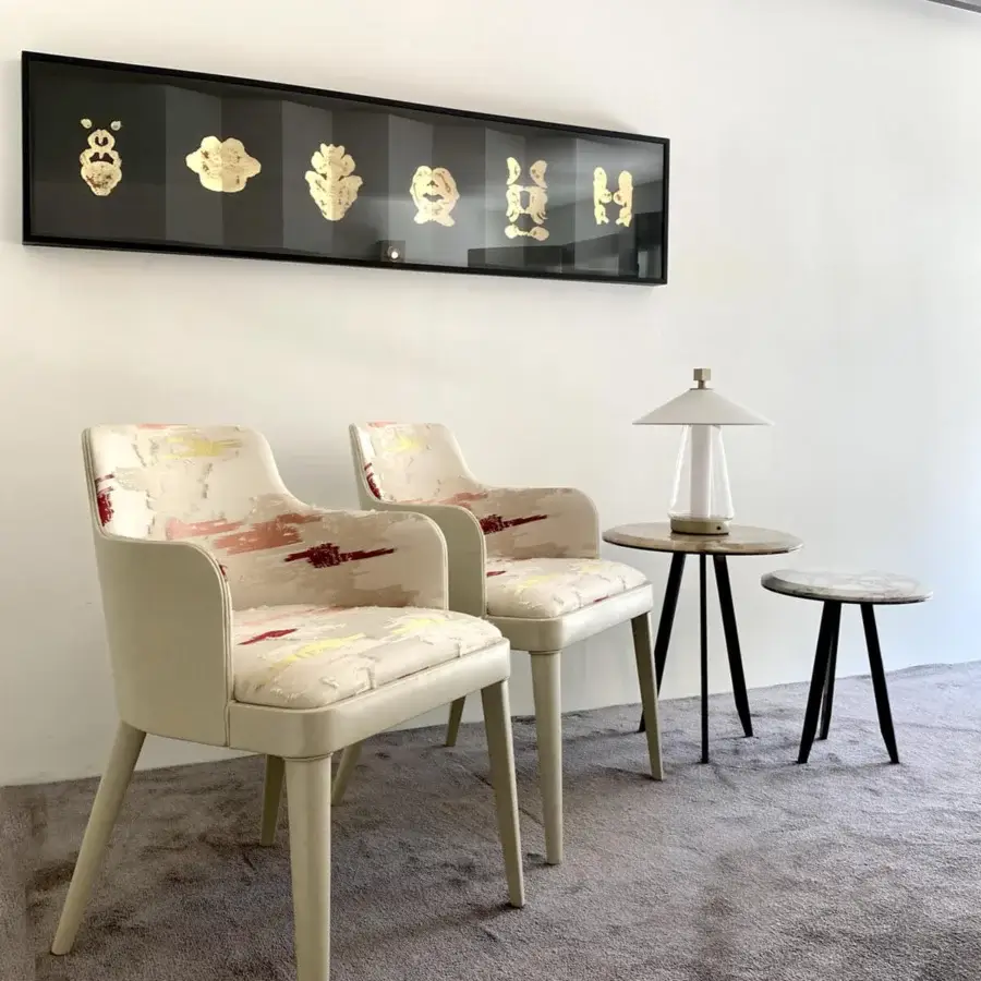Exceptional Casa Casati Lola Royale chair built with beech wood fully enveloped in supple leather and luxury fabric displaying ivory, red, yellow hues