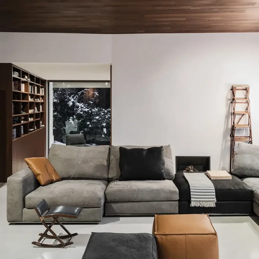Sophisticated Cierre1972 Dolce Vita sectional upholstered in soft gray textile with sleek metal base and contrasting leather pillows