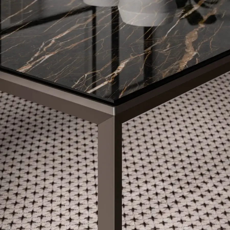 Superior Ozzio Italia Metrò table with laminated ceramic glass displaying warm brown and gold veinings in a dark matte finish