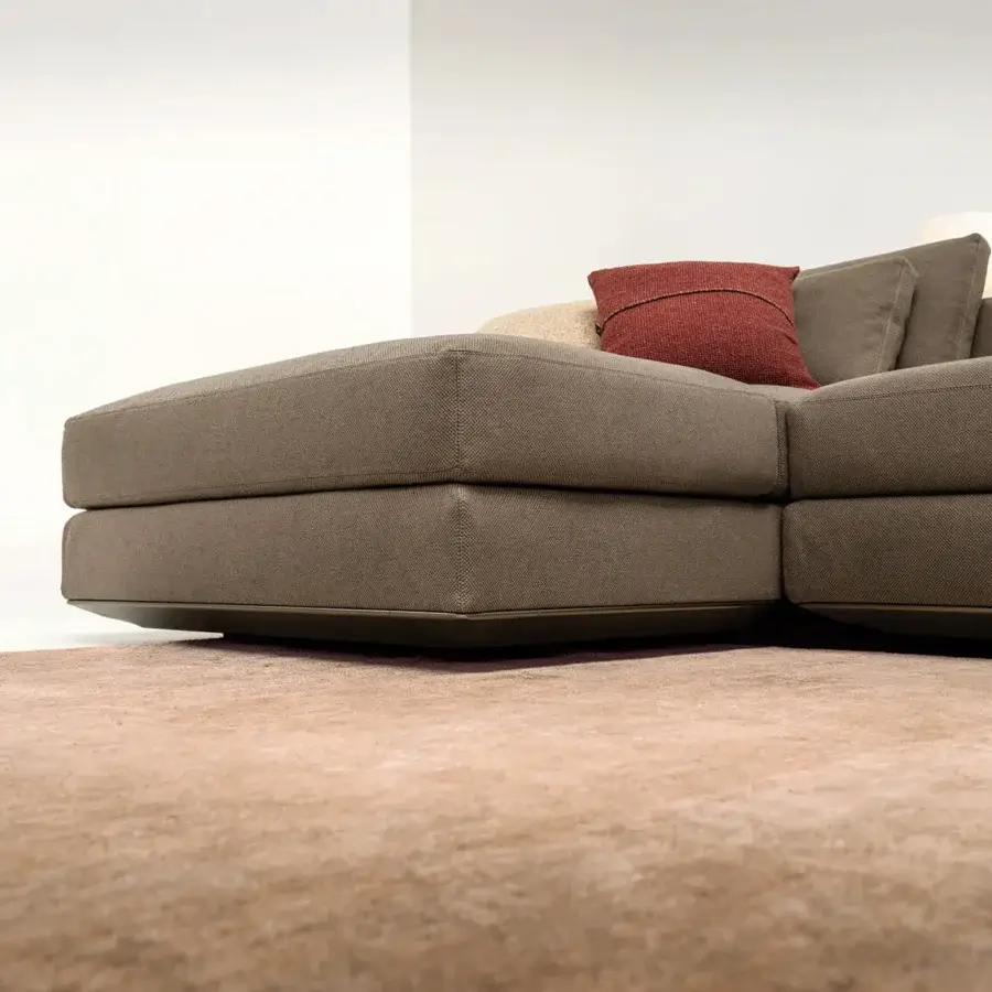 Elegant Horm Ellington sectional with medium brown textile upholstery and matte aluminum frame, accented with red