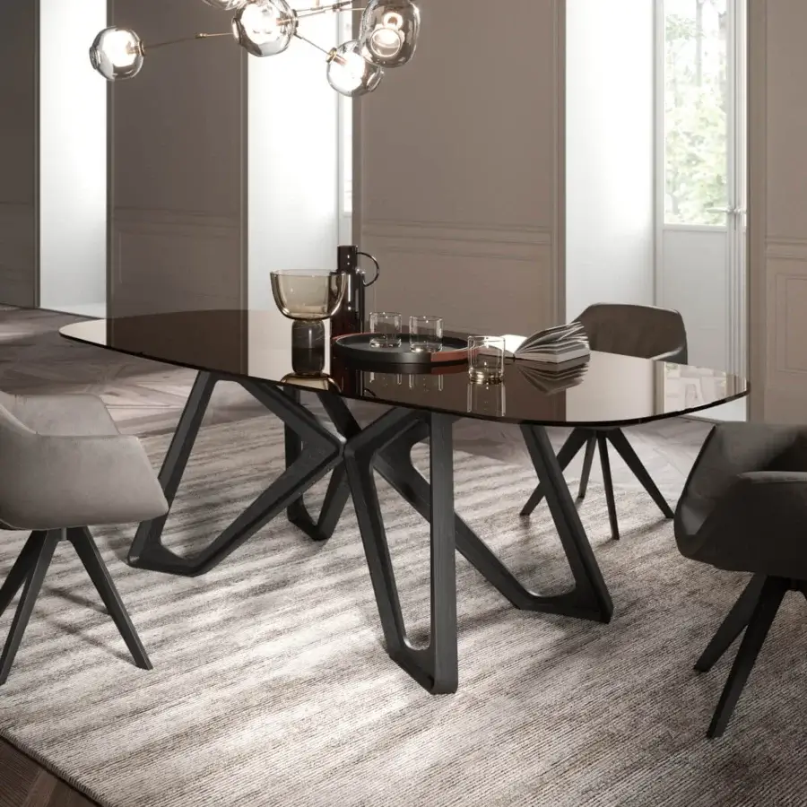 Exceptional Ozzio Italia Papillon table with a sinuous dark solid wood base and sleek tinted glass top