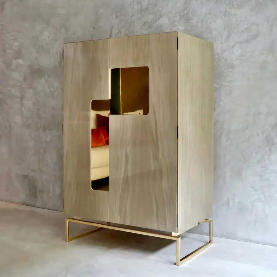 Superior Casa Casati Giorgio cupboard with light beige lacquer, visible wood grain, golden metal supports and orange finished interior